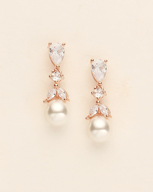 a pair of diamond and pearl earrings