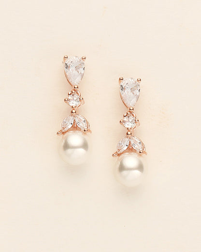 a pair of diamond and pearl earrings