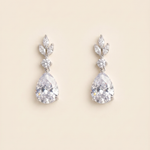 A pair of elegant diamond earrings with large, clear gemstones set in a delicate, leaf-shaped design.