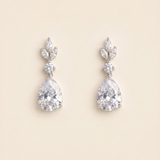 A pair of elegant diamond earrings with large, clear gemstones set in a delicate, leaf-shaped design.