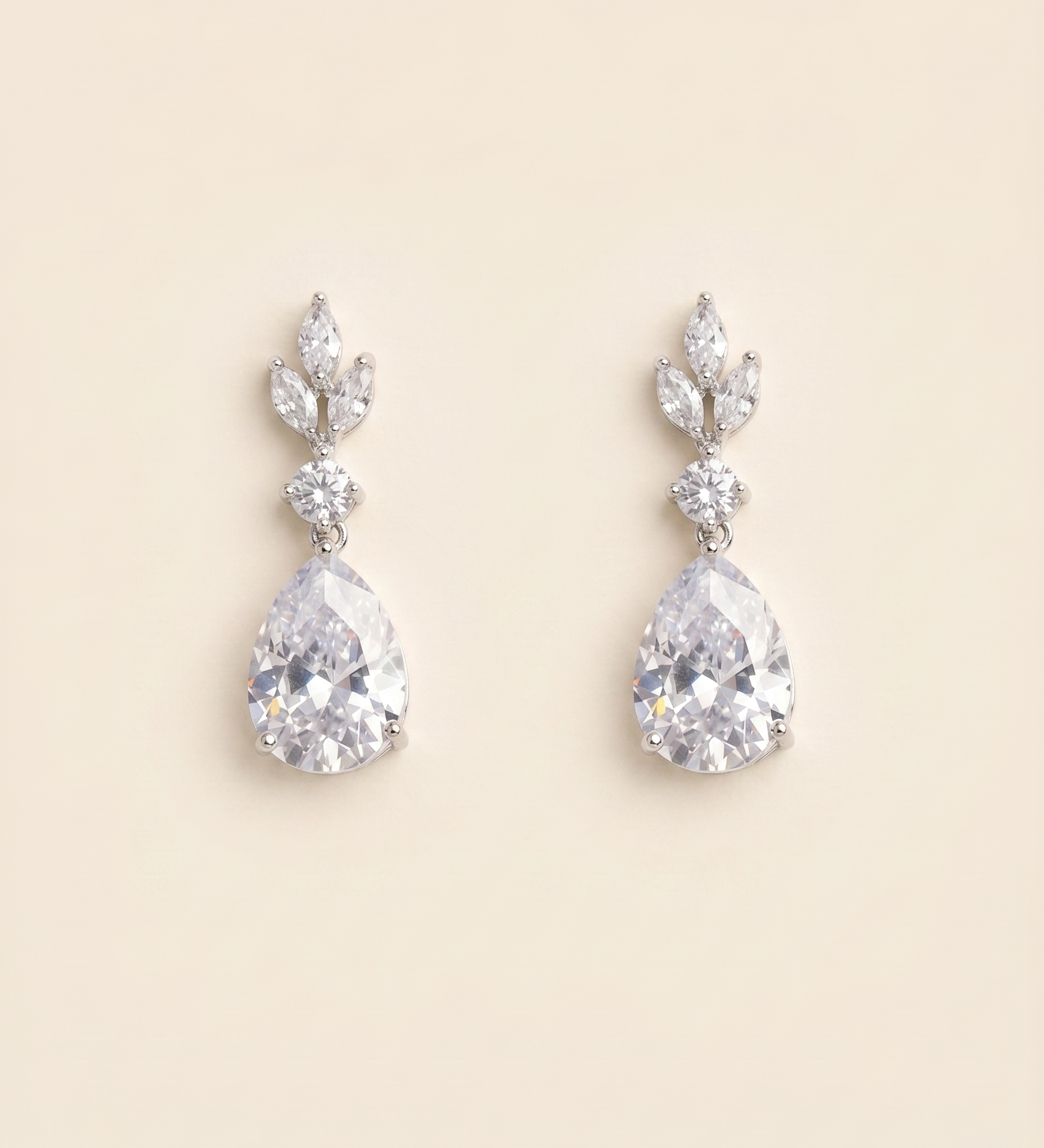 A pair of elegant diamond earrings with large, clear gemstones set in a delicate, leaf-shaped design.