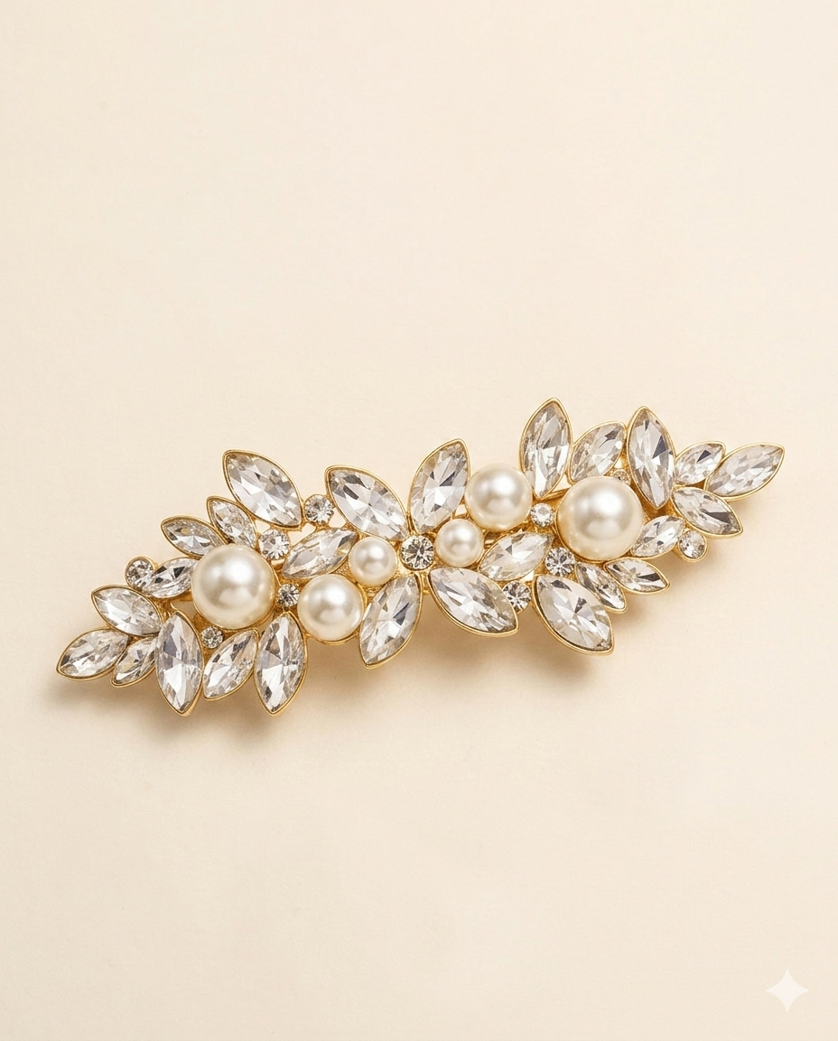 A decorative hair clip adorned with numerous sparkling crystal elements, including pearls and diamonds, set against a light beige background.