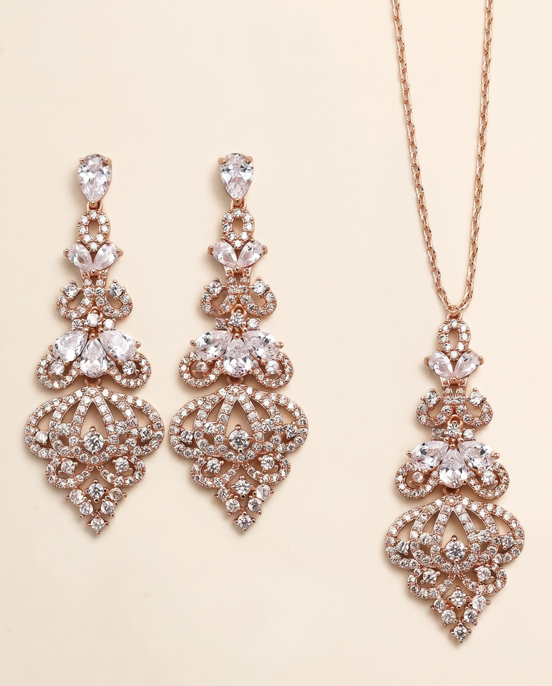 a pair of elegant earrings and a necklace adorned with sparkling rhinestones and intricate designs.