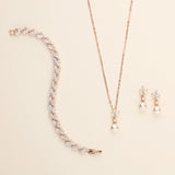 a necklace, bracelet, and earring set on a white surface