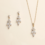 A necklace and earrings set against a light beige background.