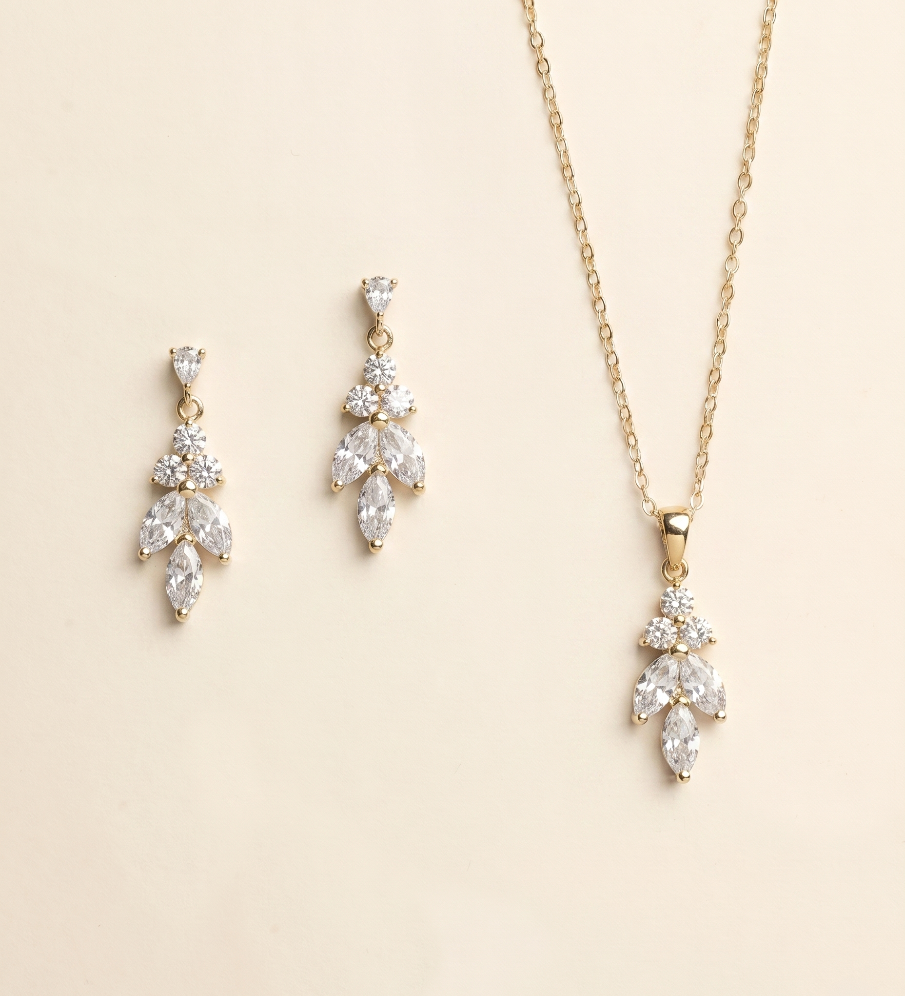 A necklace and earrings set against a light beige background.