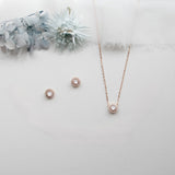 a necklace, earrings, and bracelet on a white surface