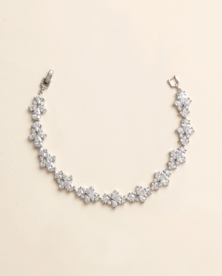 A delicate necklace with numerous small, sparkling diamonds arranged in a curved pattern.