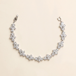 A delicate necklace with numerous small, sparkling diamonds arranged in a curved pattern.