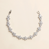 A delicate necklace with numerous small, sparkling diamonds arranged in a curved pattern.