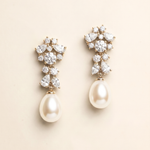 A pair of elegant earrings with a combination of pearls and diamonds.