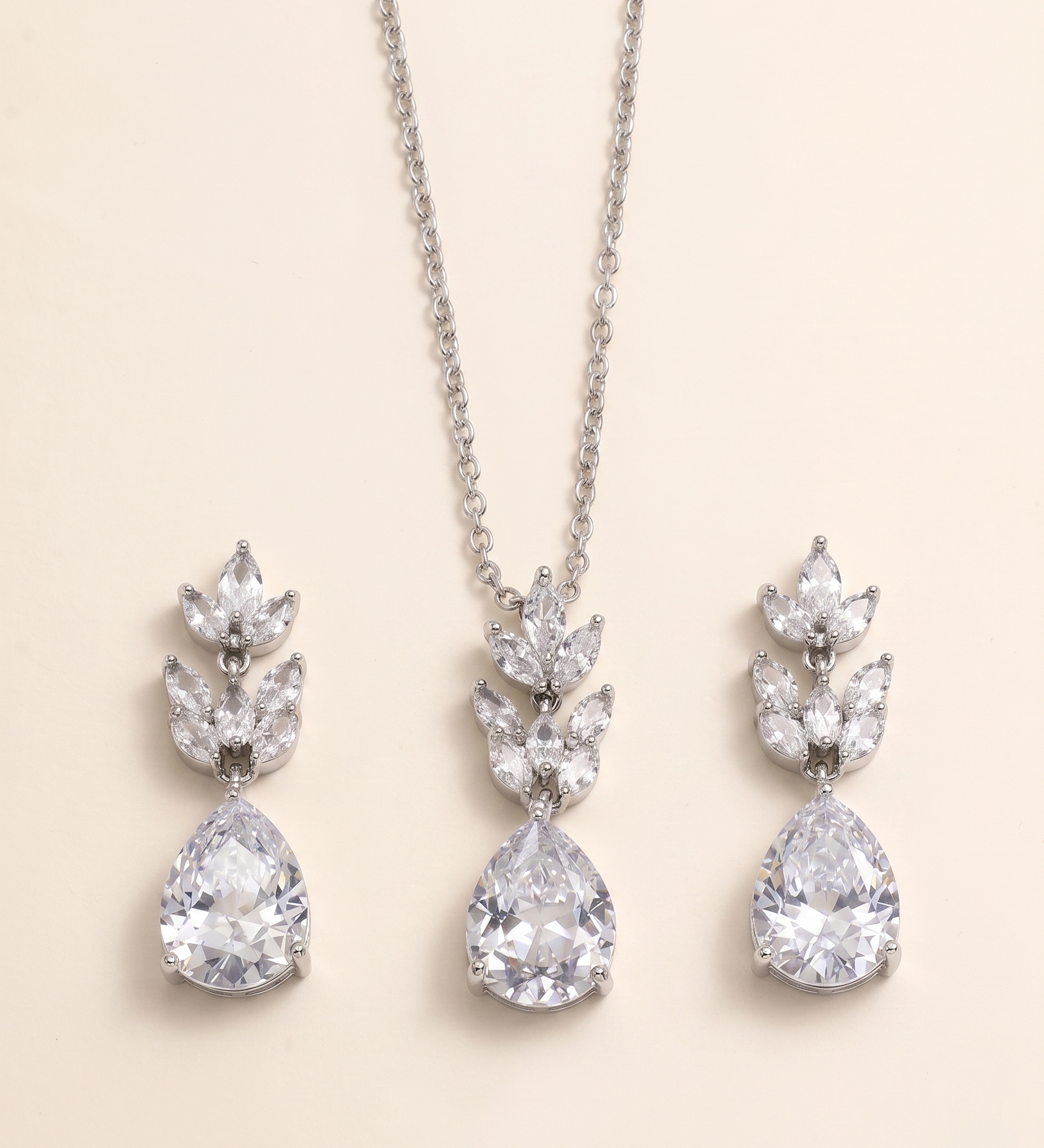 A necklace with a pendant and earrings made of large, clear gemstones.