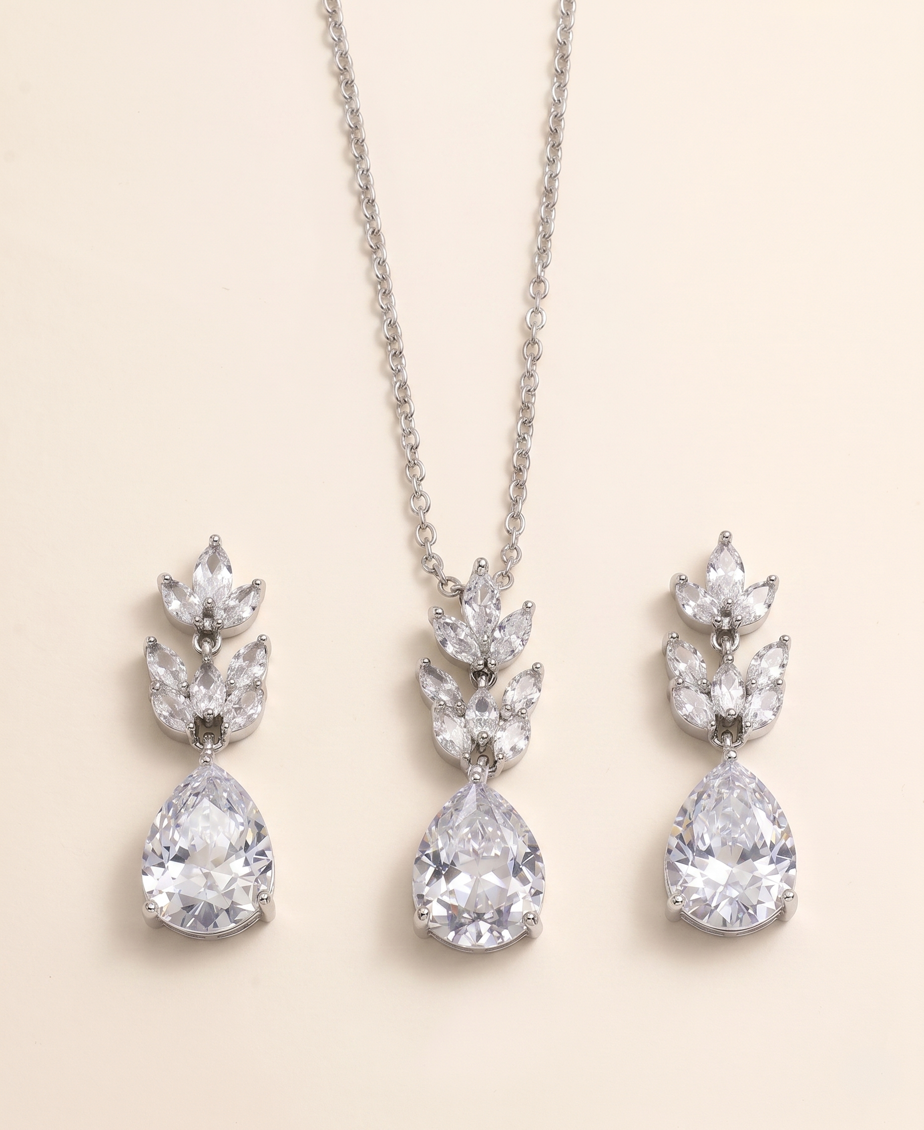 A necklace with a pendant and earrings made of large, clear gemstones.