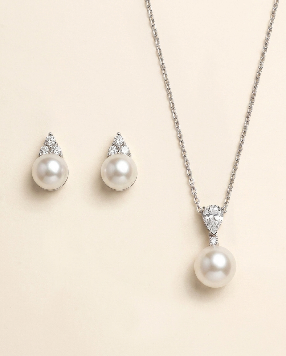 A necklace with a pendant and earrings made of pearls and diamonds.
