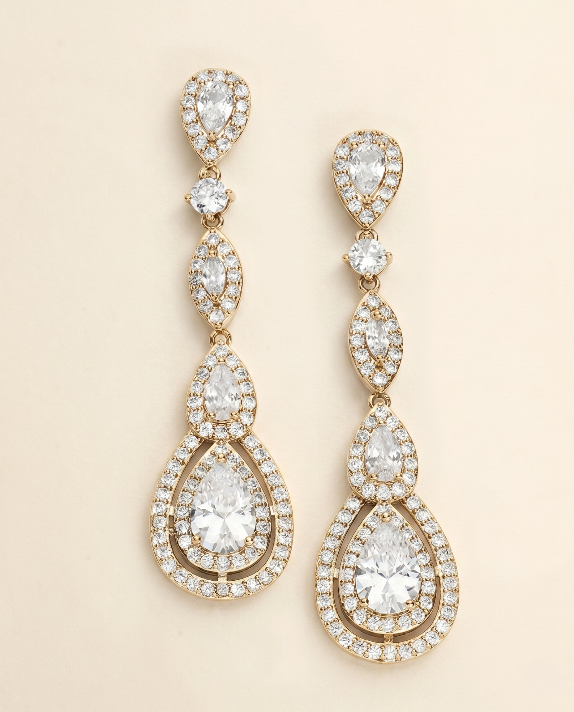 A pair of elegant gold earrings adorned with numerous sparkling diamonds.