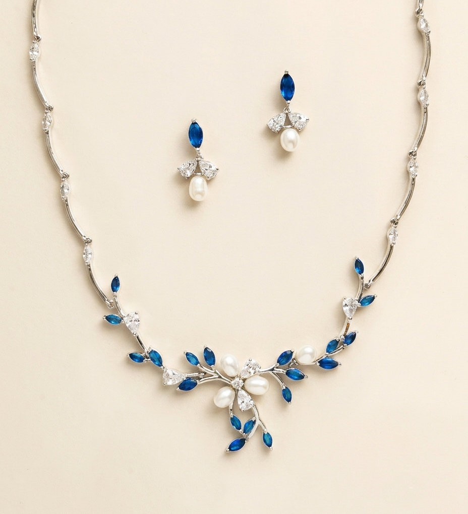 a necklace and earrings set with blue and white gemstones, including pearls and diamonds.