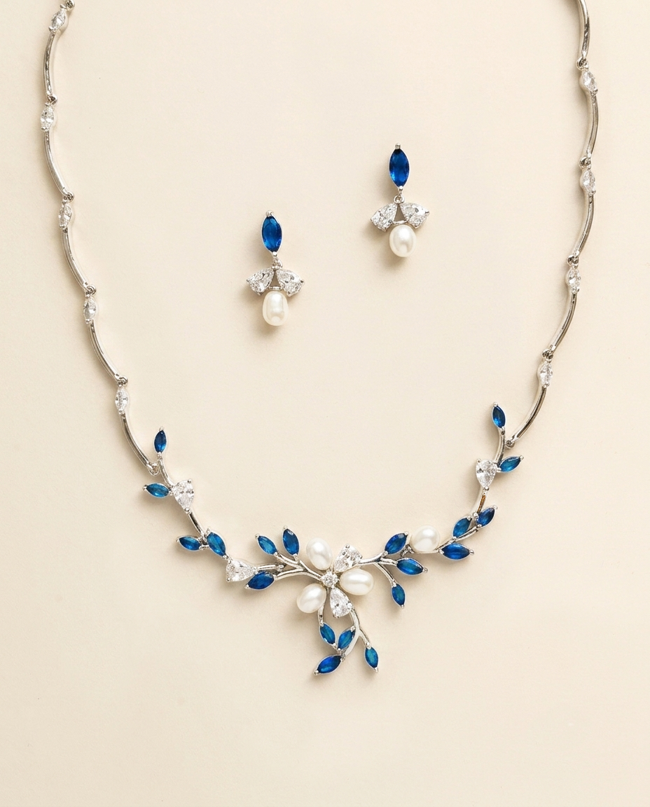 a necklace and earrings set with blue and white gemstones, including pearls and diamonds.