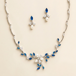 a necklace and earrings set with blue and white gemstones, including pearls and diamonds.