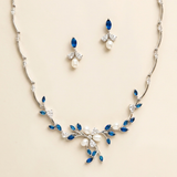 a necklace and earrings set with blue and white gemstones, including pearls and diamonds.