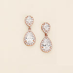 a pair of diamond earrings on a white background