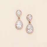 a pair of diamond earrings on a white background