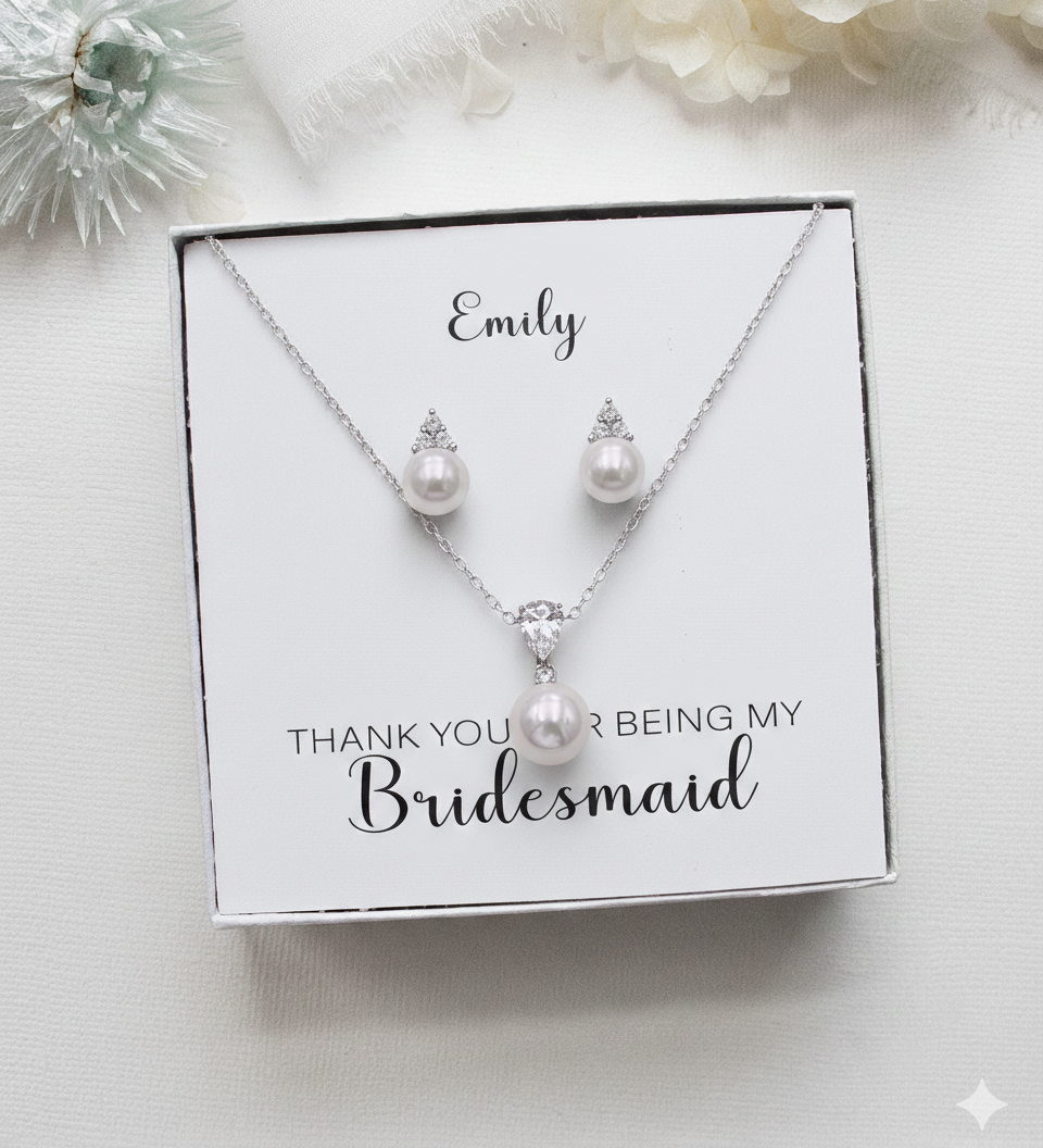 A necklace and earrings set in a white box, with a personalized message on the box.