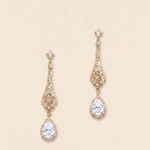 A pair of elegant gold earrings with large, clear gemstones hanging from the bottom.