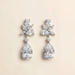 A pair of elegant diamond earrings with large, clear gemstones set in a delicate, floral-inspired design.