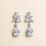 A pair of elegant diamond earrings with large, clear gemstones set in a delicate, floral-inspired design.