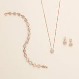 a necklace, earrings, and bracelet on a white surface