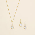 a necklace and earring set with a white diamond