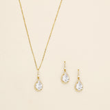 a necklace and earring set with a white diamond
