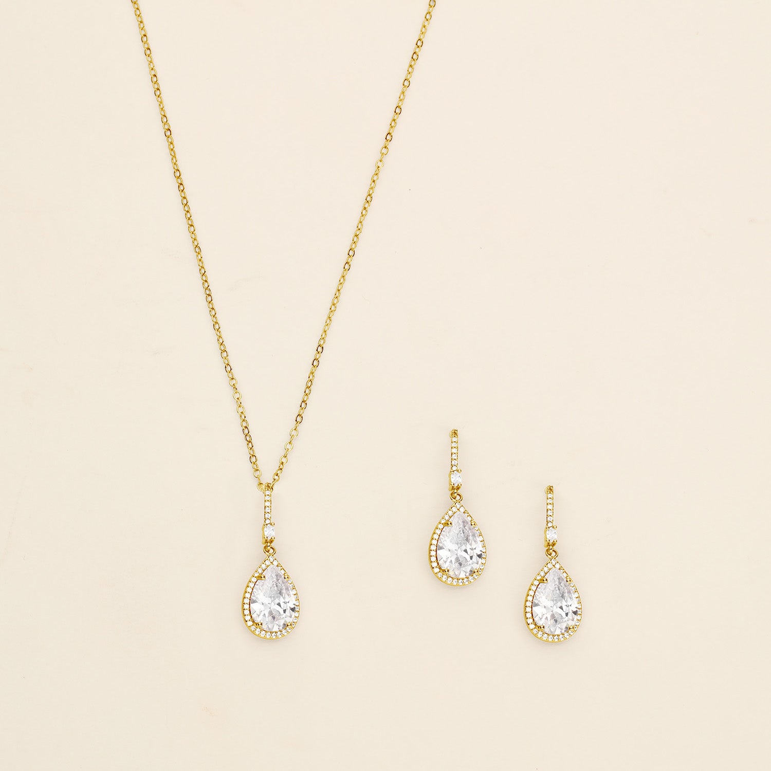 a necklace and earring set with a white diamond