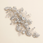 A decorative piece of jewelry with a combination of clear and silver elements, including leaves and crystals, set against a light beige background.