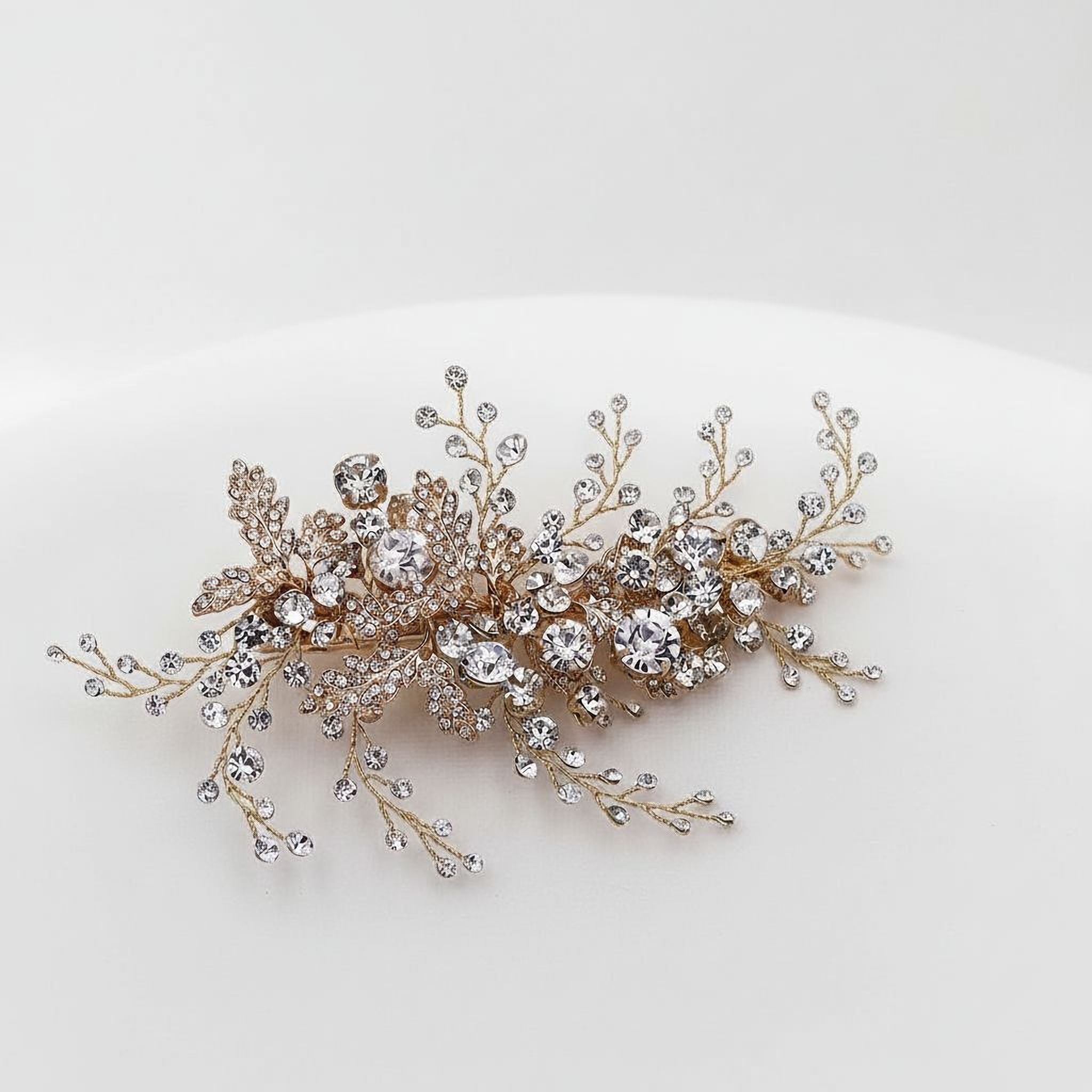 A decorative piece of jewelry with a floral design and numerous sparkling diamonds.
