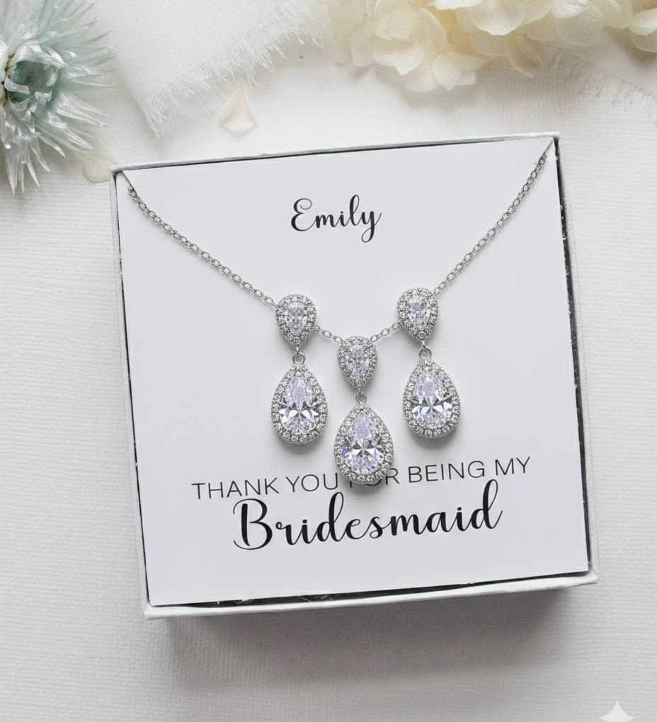 A necklace with a pendant and earrings is displayed in a white box, accompanied by a personalized message that reads "Thank you for being my Bridesmaid".