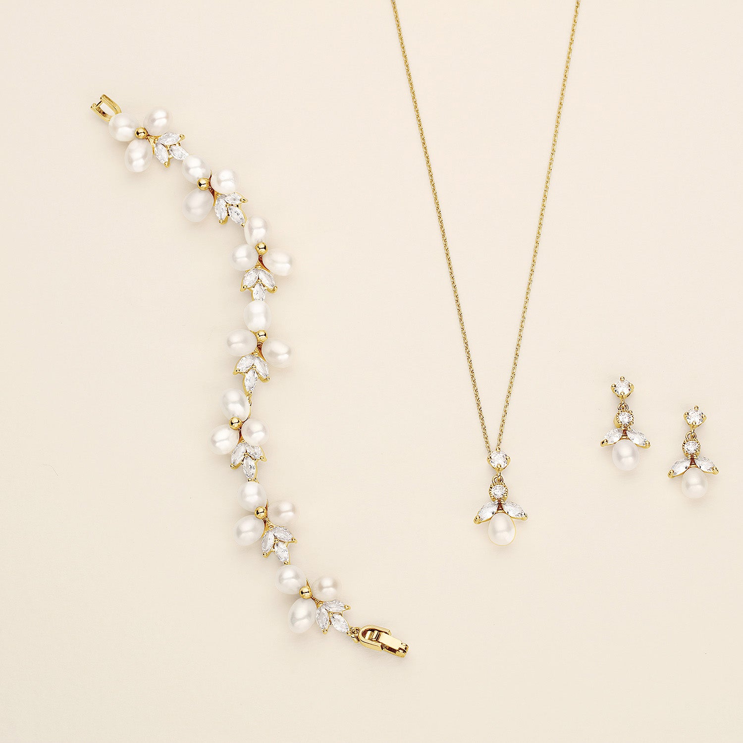 a necklace, earring, and necklace with pearls