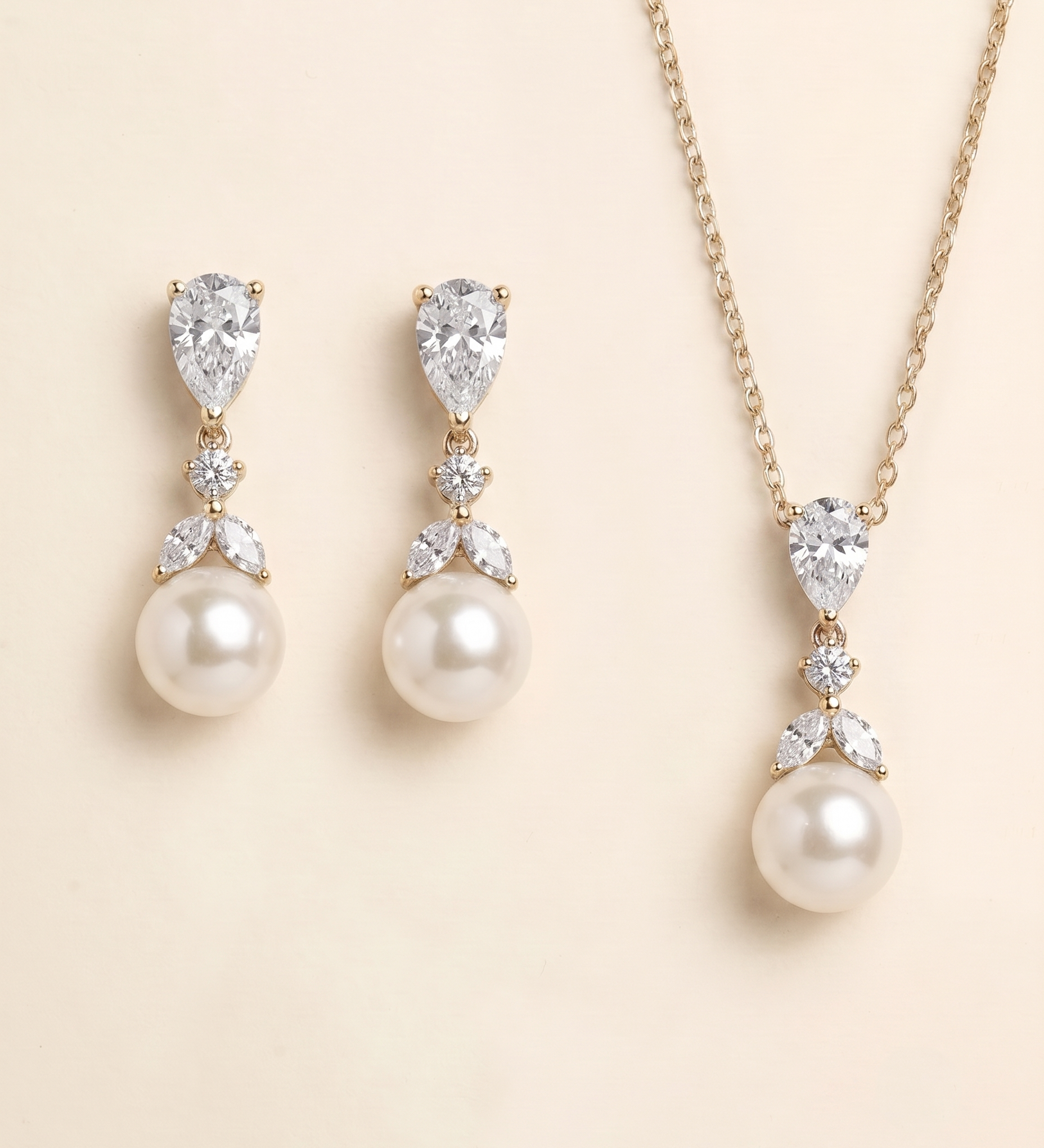 A set of elegant pearl and diamond jewelry, including earrings and a necklace, displayed against a light beige background.