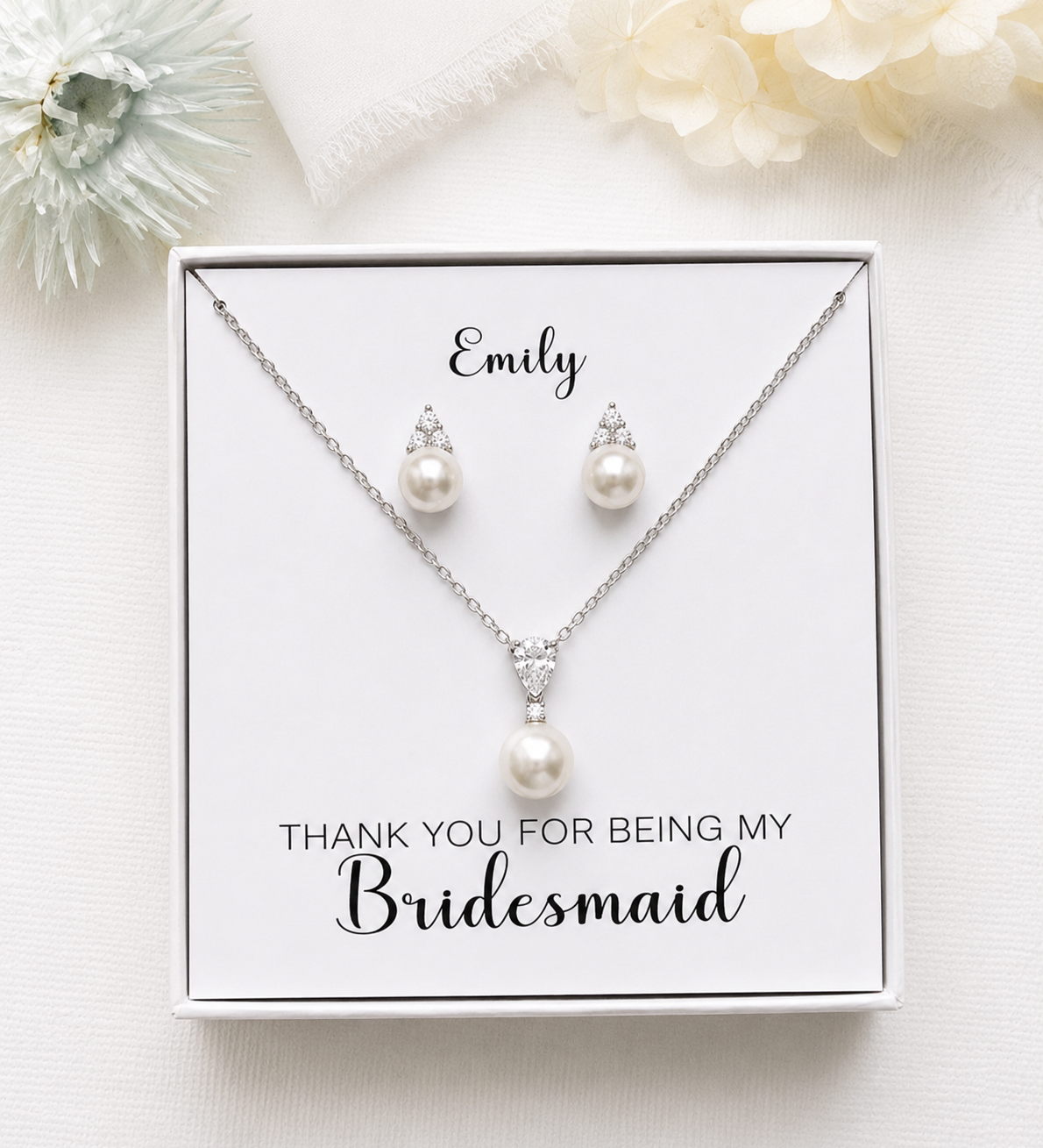 A necklace and earring set presented in a white box, with a personalized message on the box.