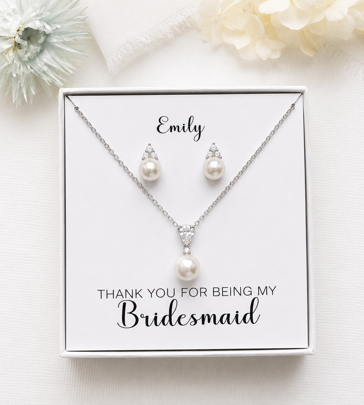 A necklace and earring set presented in a white box, with a personalized message on the box.