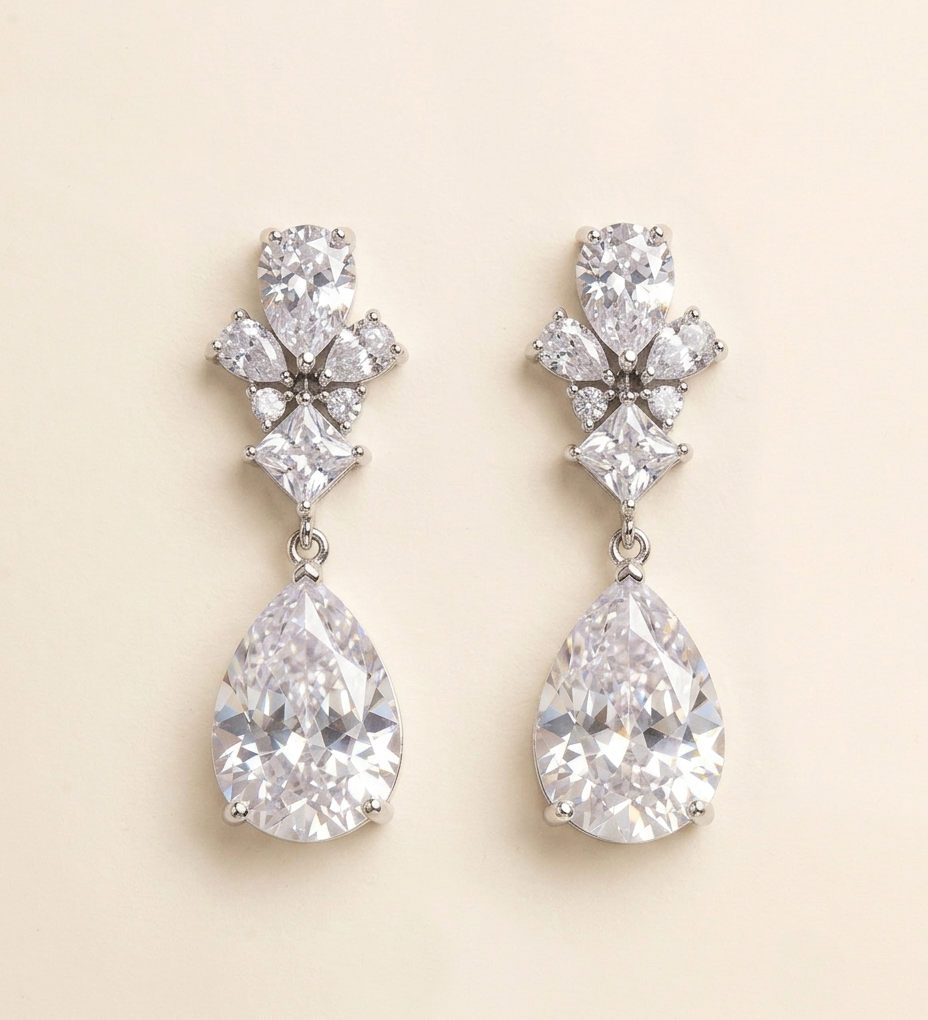 A pair of elegant earrings with large, clear gemstones hanging from the ear lobes.