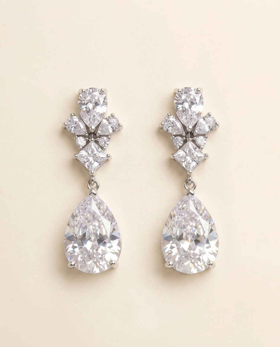 A pair of elegant earrings with large, clear gemstones hanging from the ear lobes.