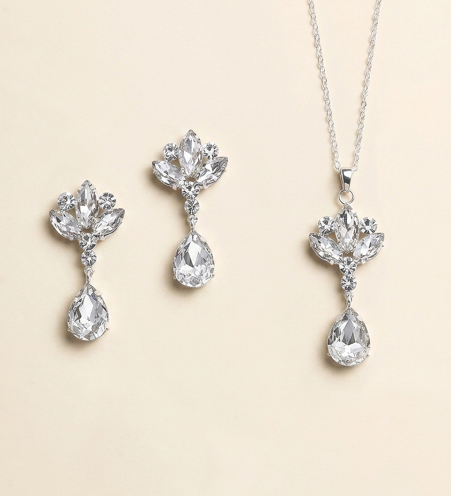 a set of elegant jewelry pieces, including a necklace and earrings, all featuring large, sparkling crystal stones.