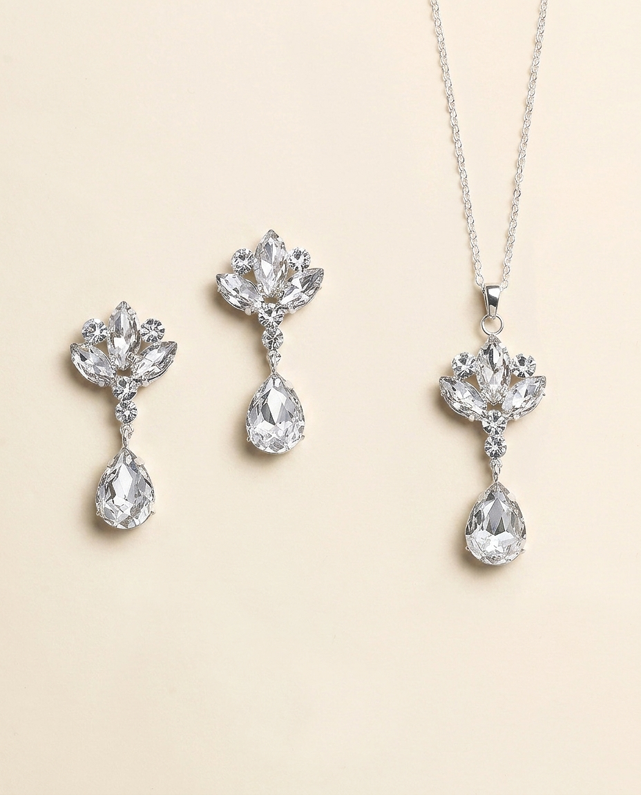 a set of elegant jewelry pieces, including a necklace and earrings, all featuring large, sparkling crystal stones.