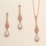 a set of elegant jewelry pieces, including earrings and a necklace, all featuring intricate designs and sparkling gemstones.