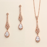a set of elegant jewelry pieces, including earrings and a necklace, all featuring intricate designs and sparkling gemstones.