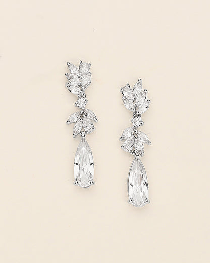 a pair of diamond earrings on a white background