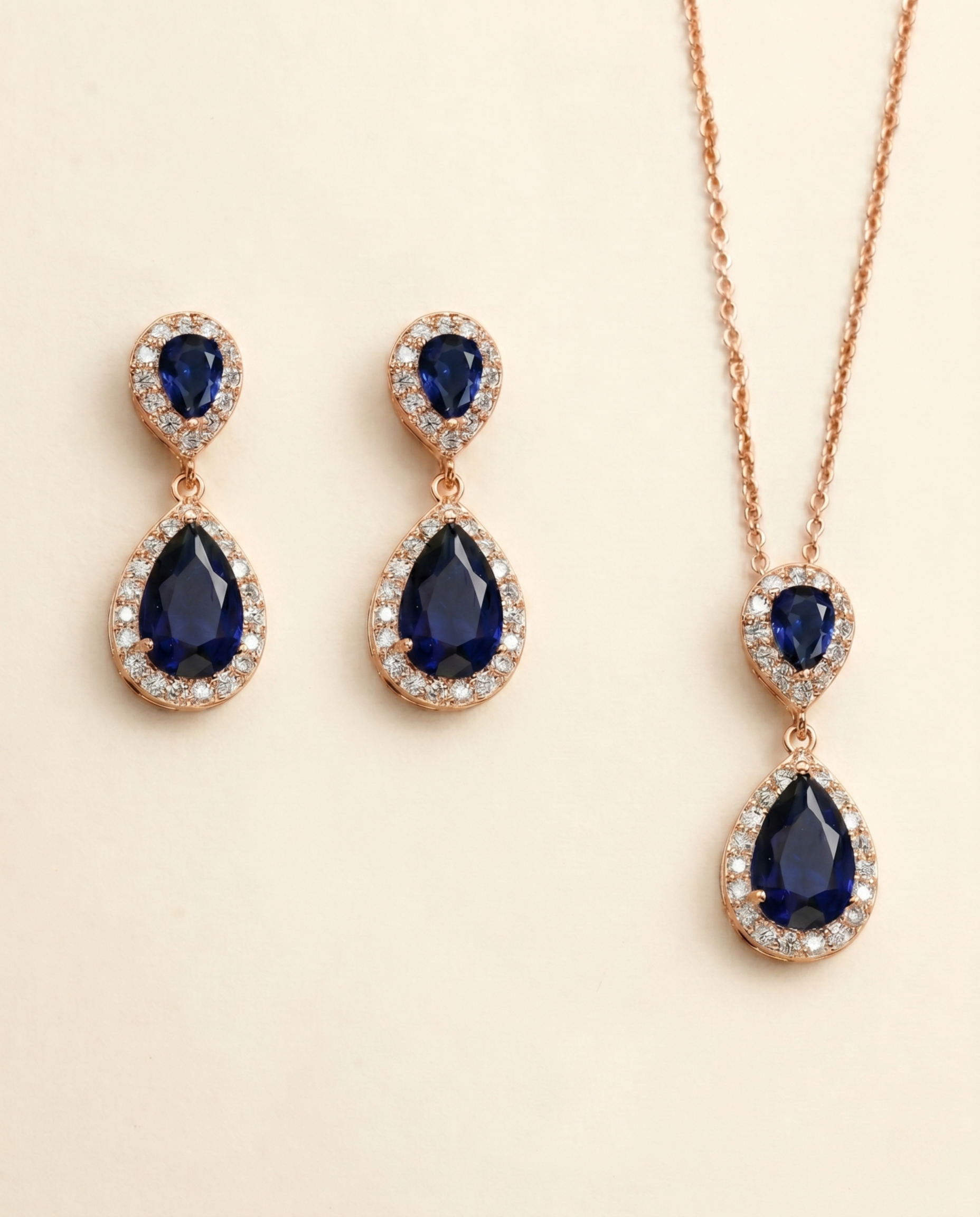A pair of elegant earrings and a necklace featuring a combination of blue gemstones and sparkling diamonds.