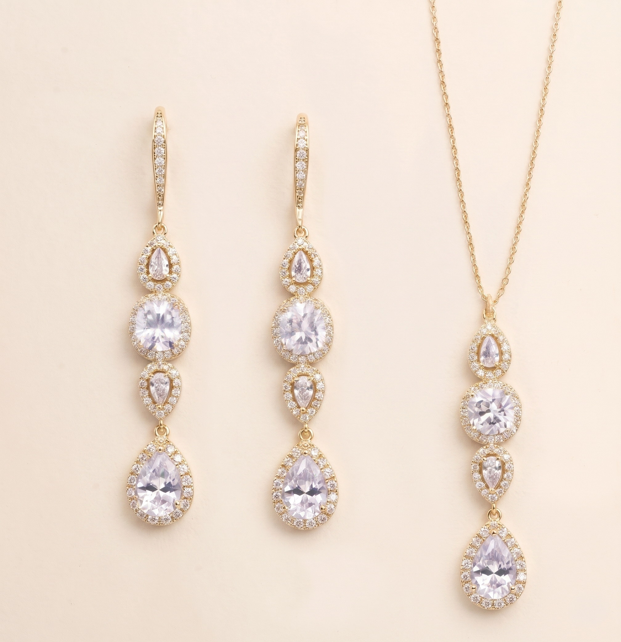 a set of elegant gold jewelry pieces, including earrings and a necklace, featuring a delicate and intricate design with numerous small pear-shaped gemstones.