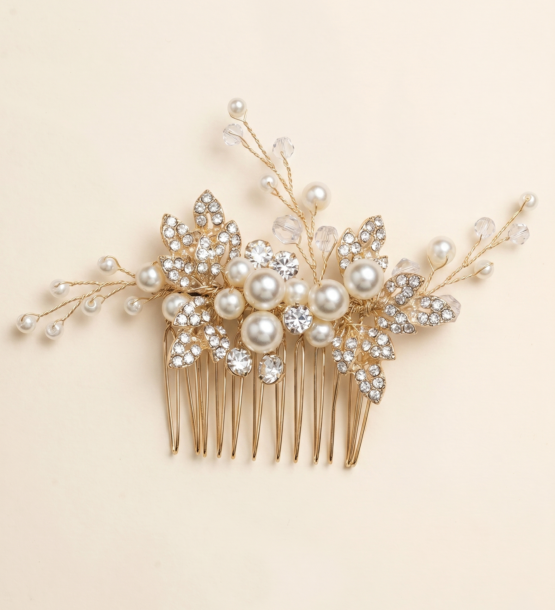 A decorative gold hairbrush adorned with pearls and crystal embellishments.